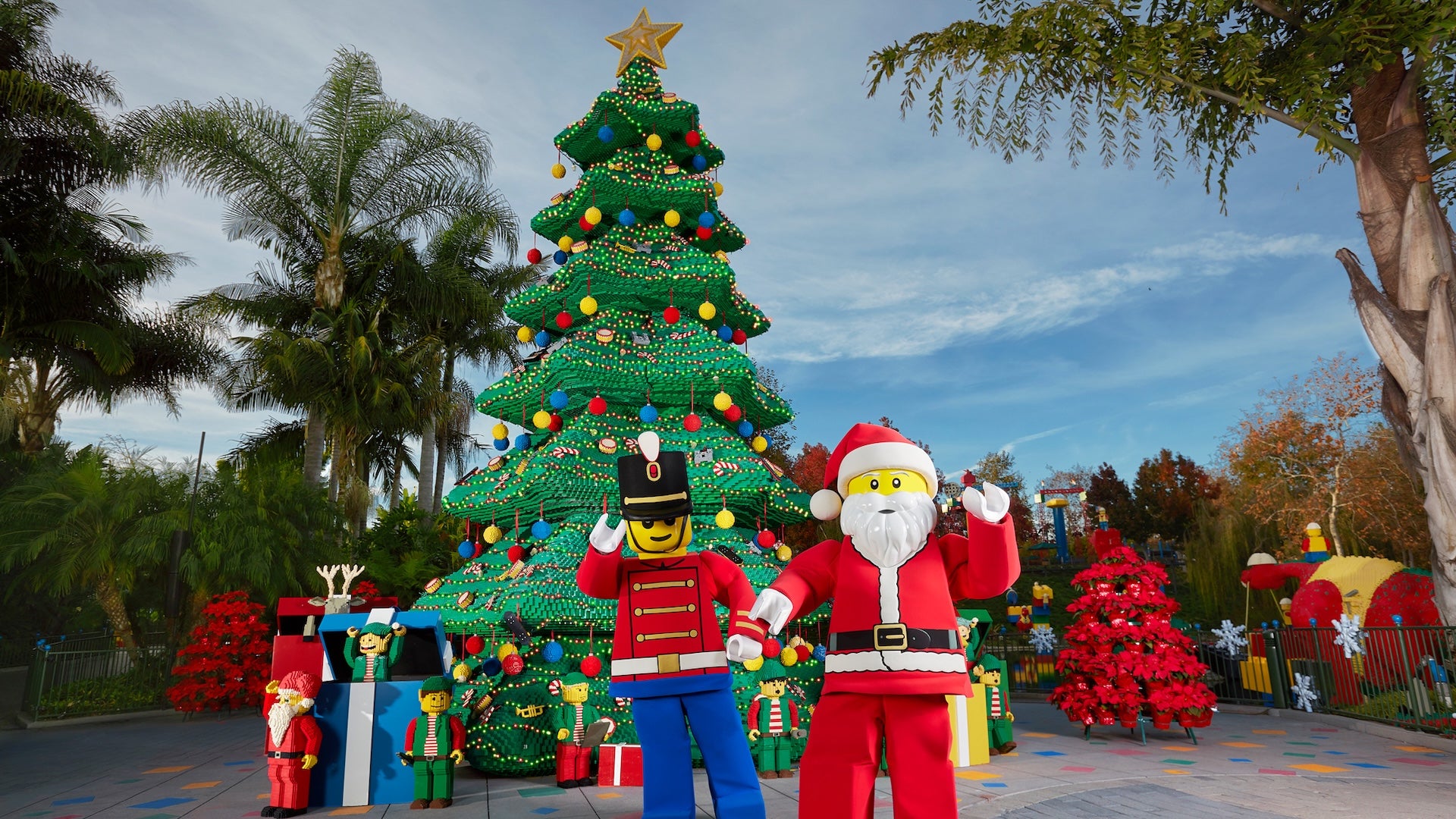 Santa and toy soldier lego characters standing in front of a lego tree